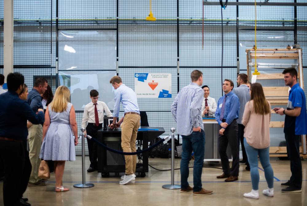 Students and guests view projects in the design bay